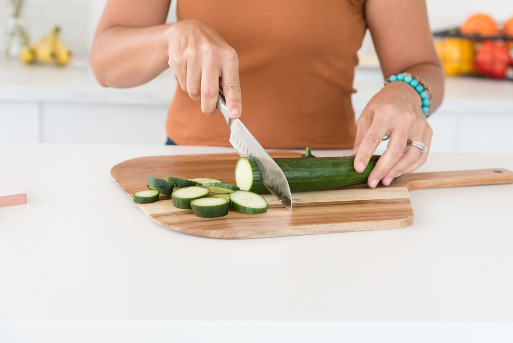 woman cutting cucumbers