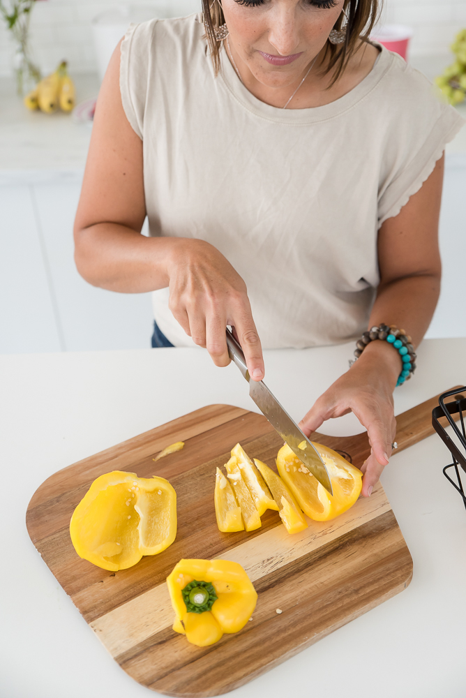 woman cutting peppers